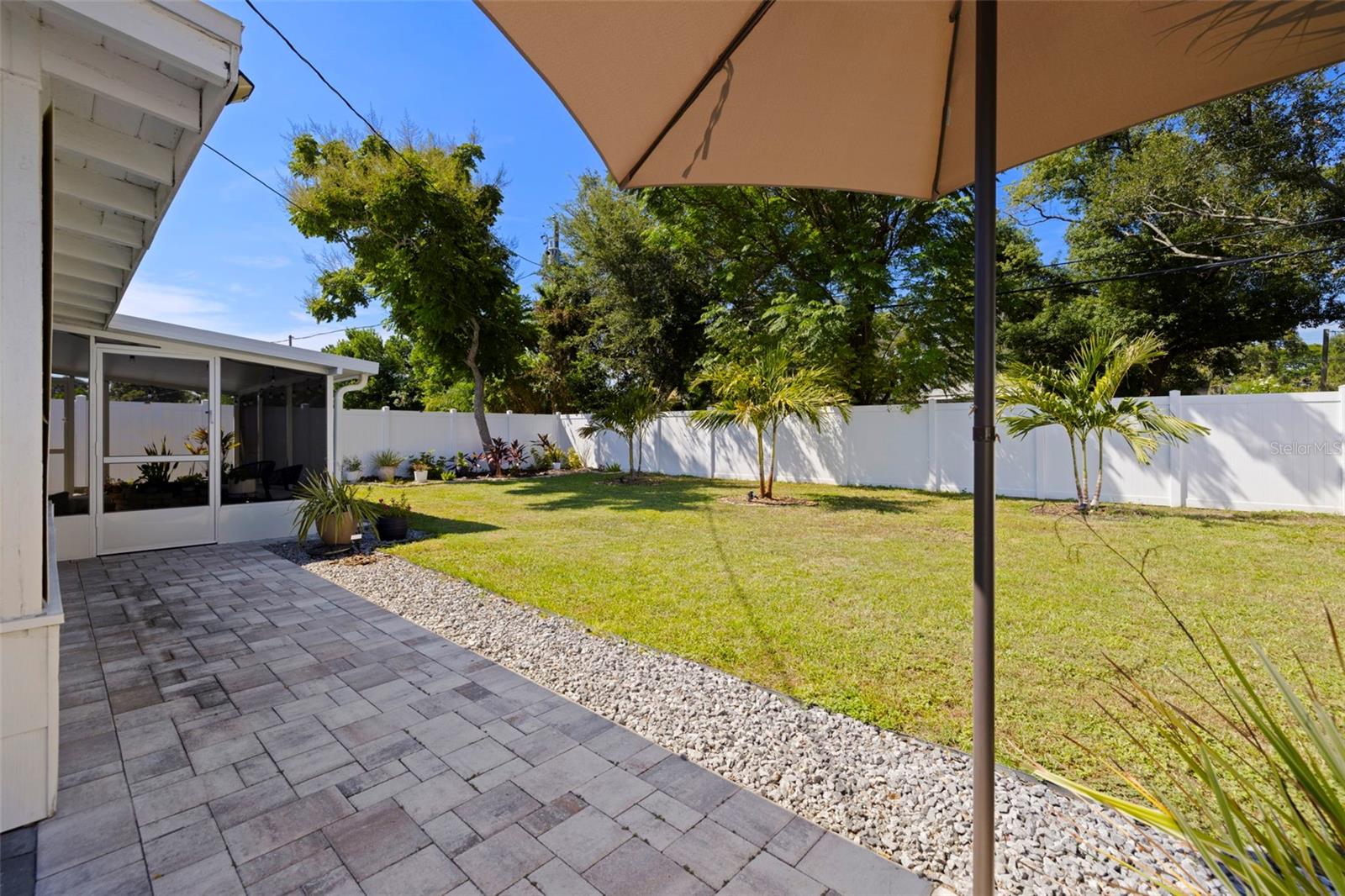 Side pavered patio and huge backyard