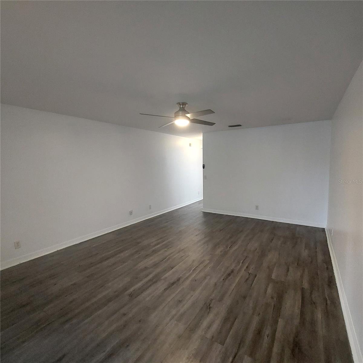 spacious living room with ceiling fan
