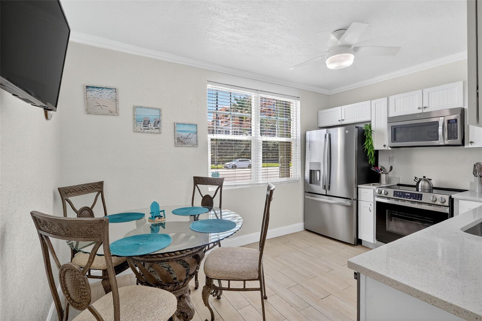 The kitchen area has seating for 4, and  stainess appliances