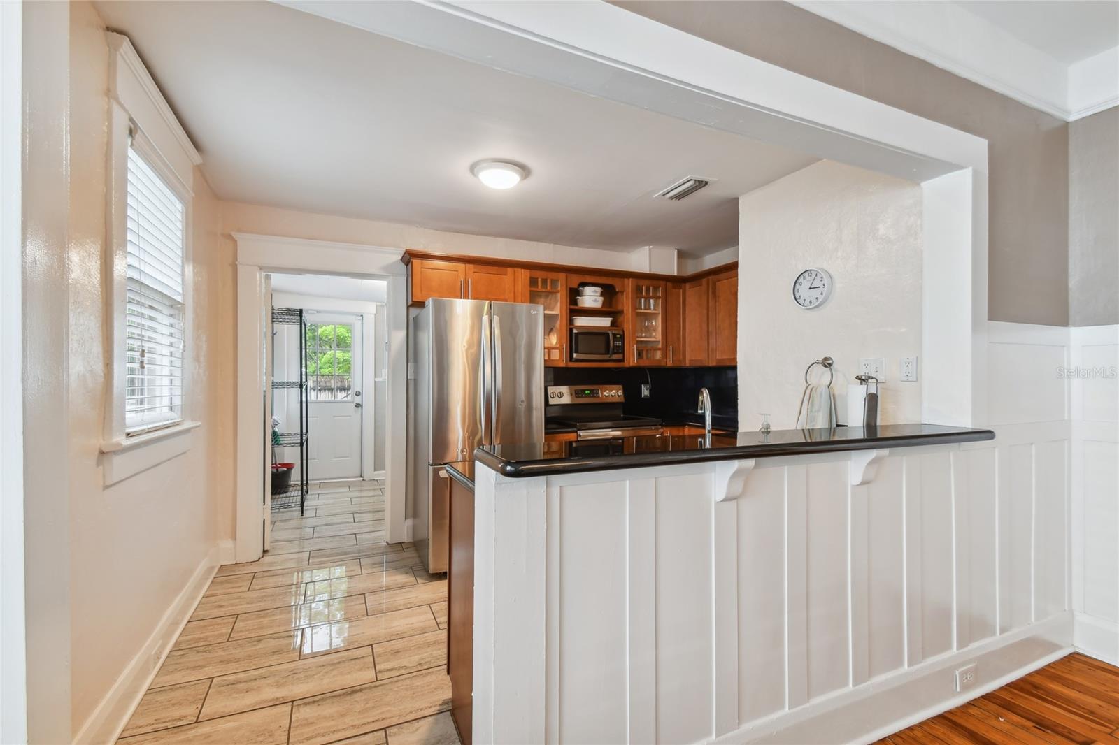 Open kitchen with access to laundry room and back yard