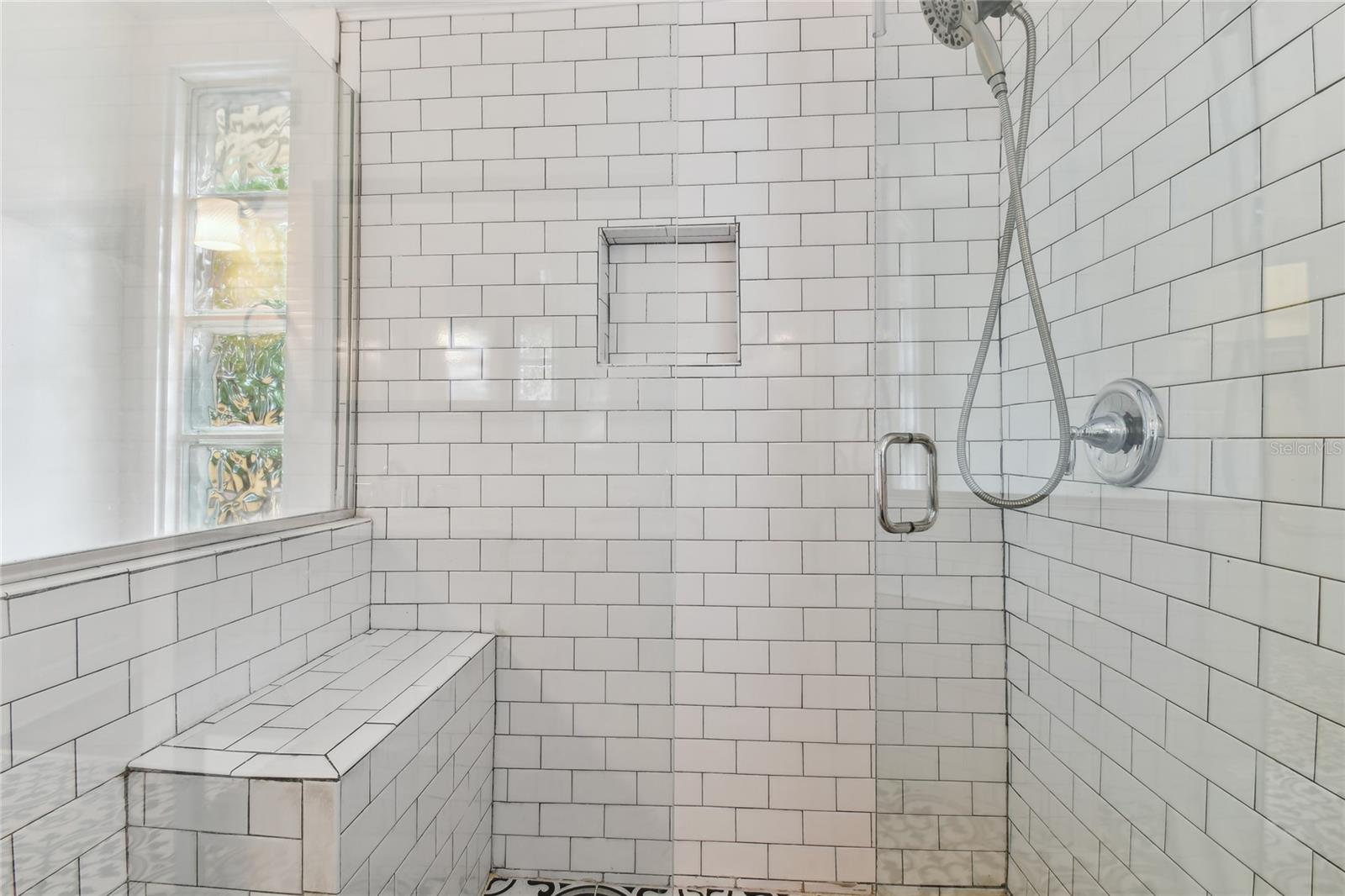 Large, tile and glass enclosed shower in primary bath