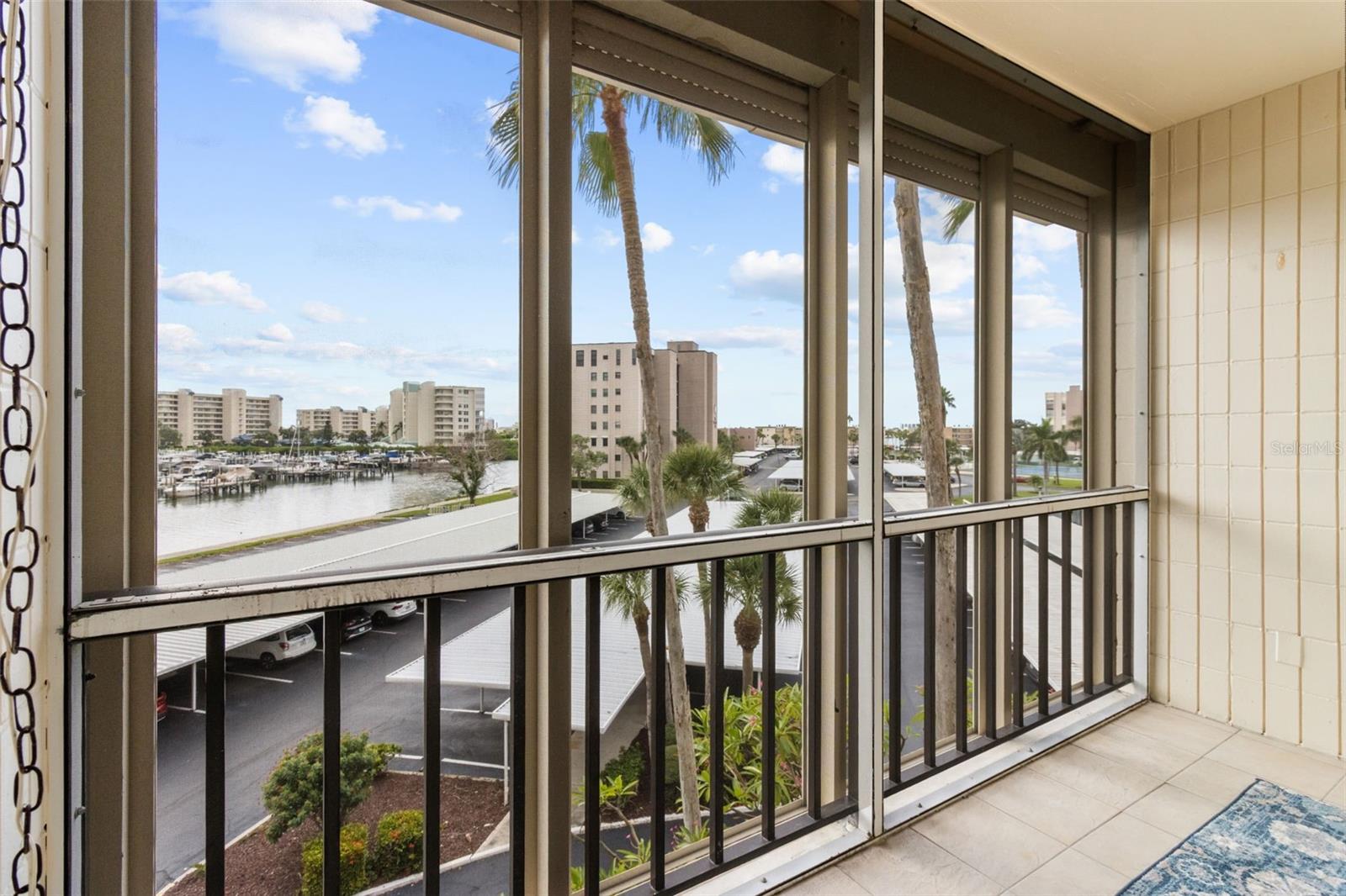 THE TILED BALCONY IS SCREENED WITH ELECTRIC AND MANUEL SHUTTERS.  ENJOY THE BAY BREEZES!