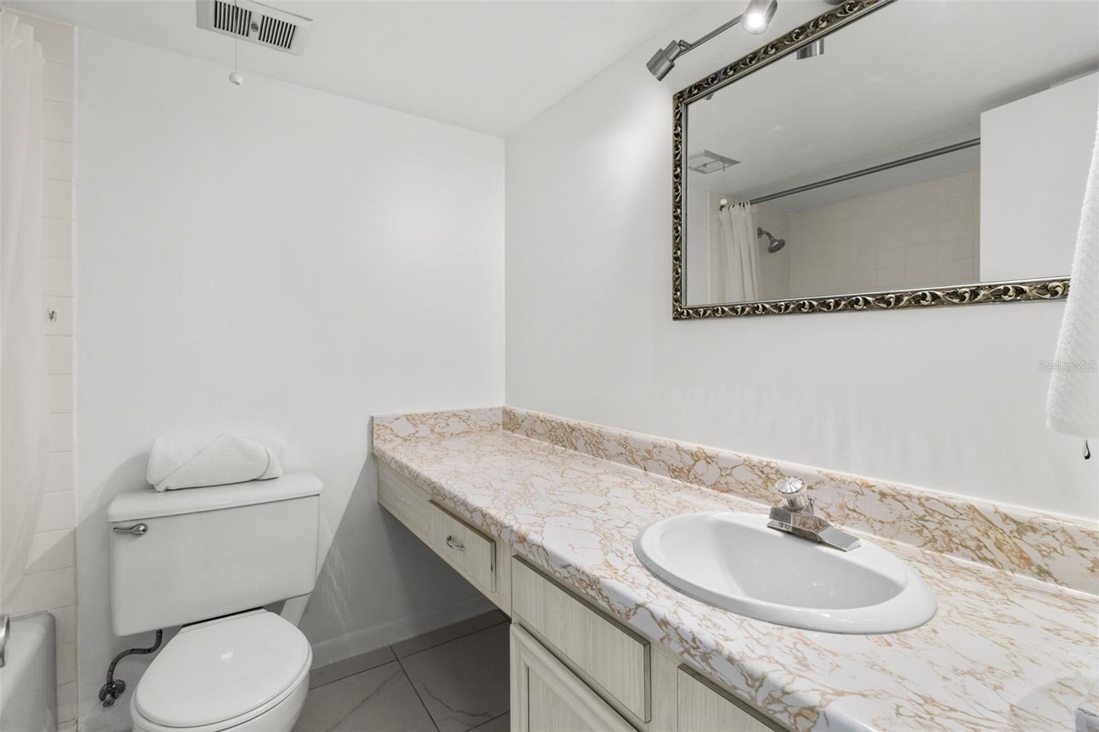 THE ENSUITE BATHROOM OFFERS A LARGE VANITY, TUB AND SHOWER!