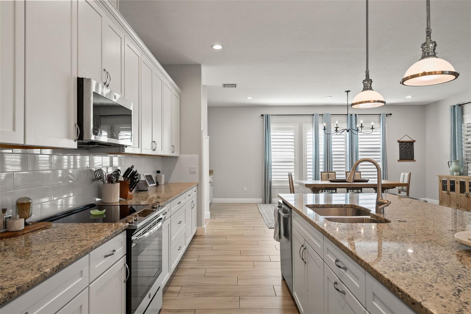 Functional design with abundant cabinet storage and a large island overlooking the dining area.