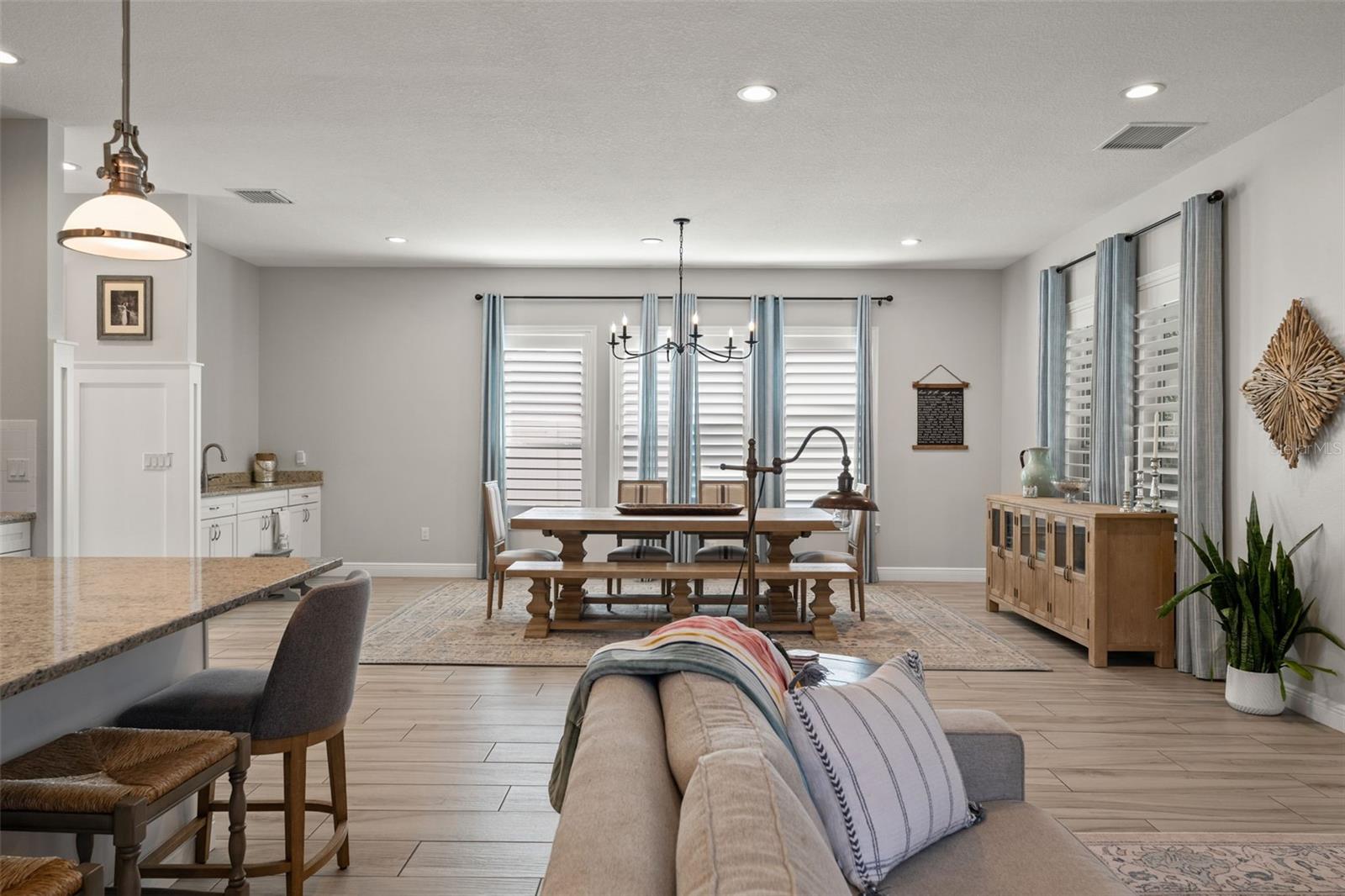 Central gathering space blending style and comfort, with easy access to both kitchen and dining areas.