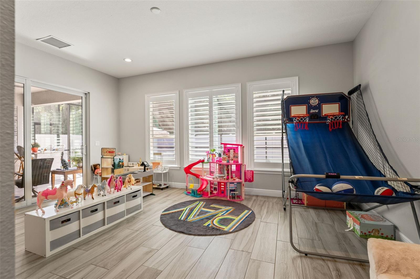 Generous windows bring in natural light, with direct access to the patio and backyard.