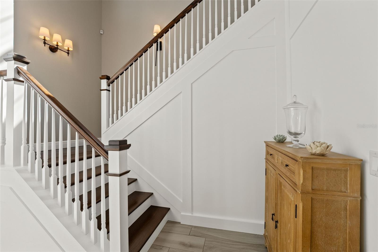 Elegant staircase with dark wood treads, white risers, and custom trim detail for a timeless design.