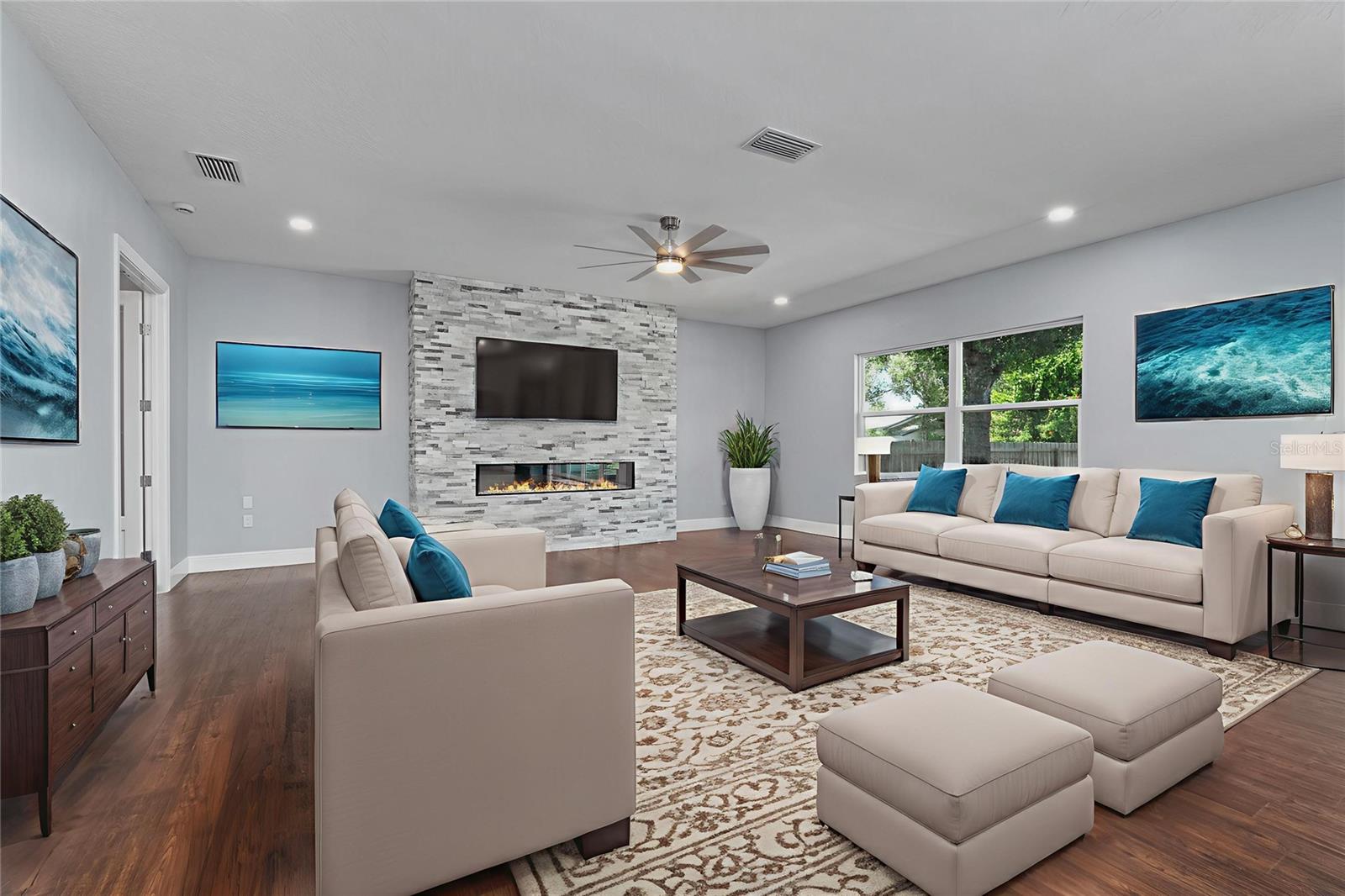 Spacious Family Room with stylish stone fireplace, French Doors to left lead to Office
