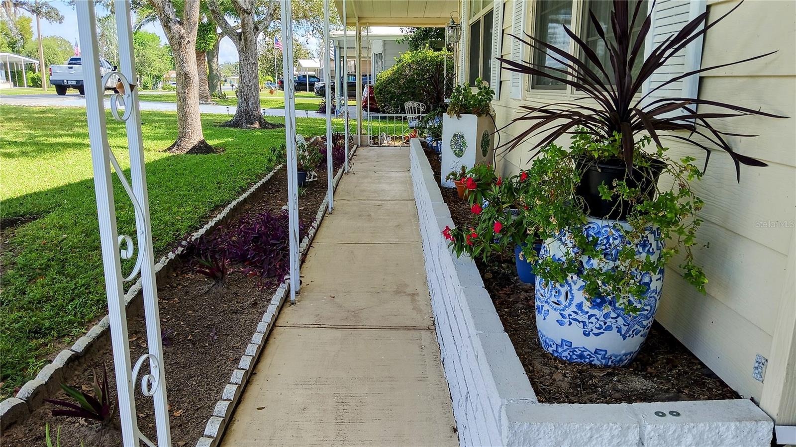 Sidewalk leads to front patio and side porch