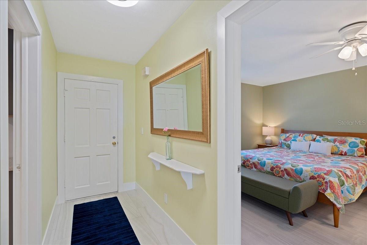 Inviting entryway with bedroom to the left and kitchen to the right