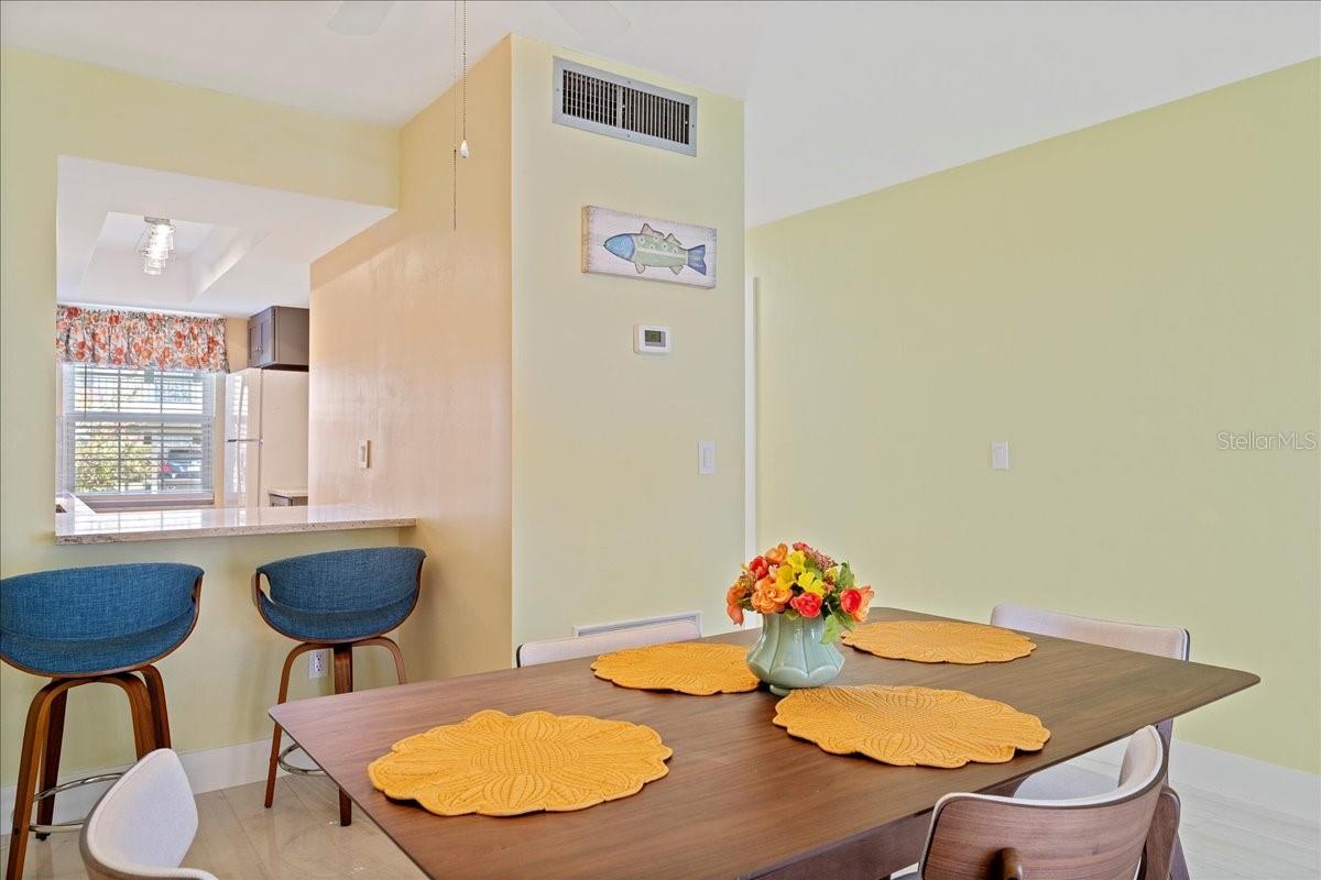 A convenient pass-through to the dining area provides the perfect spot to pull up a stool for a quick, casual meal.