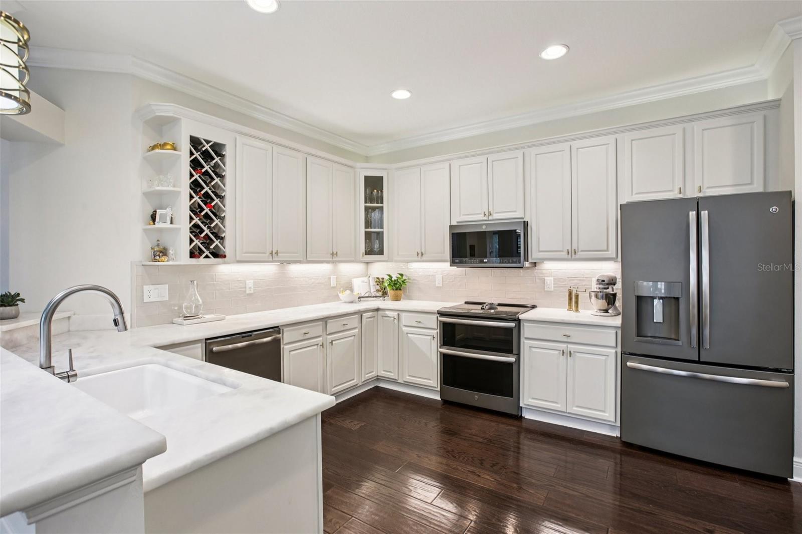 Kitchen features marble counters, stainless appliances