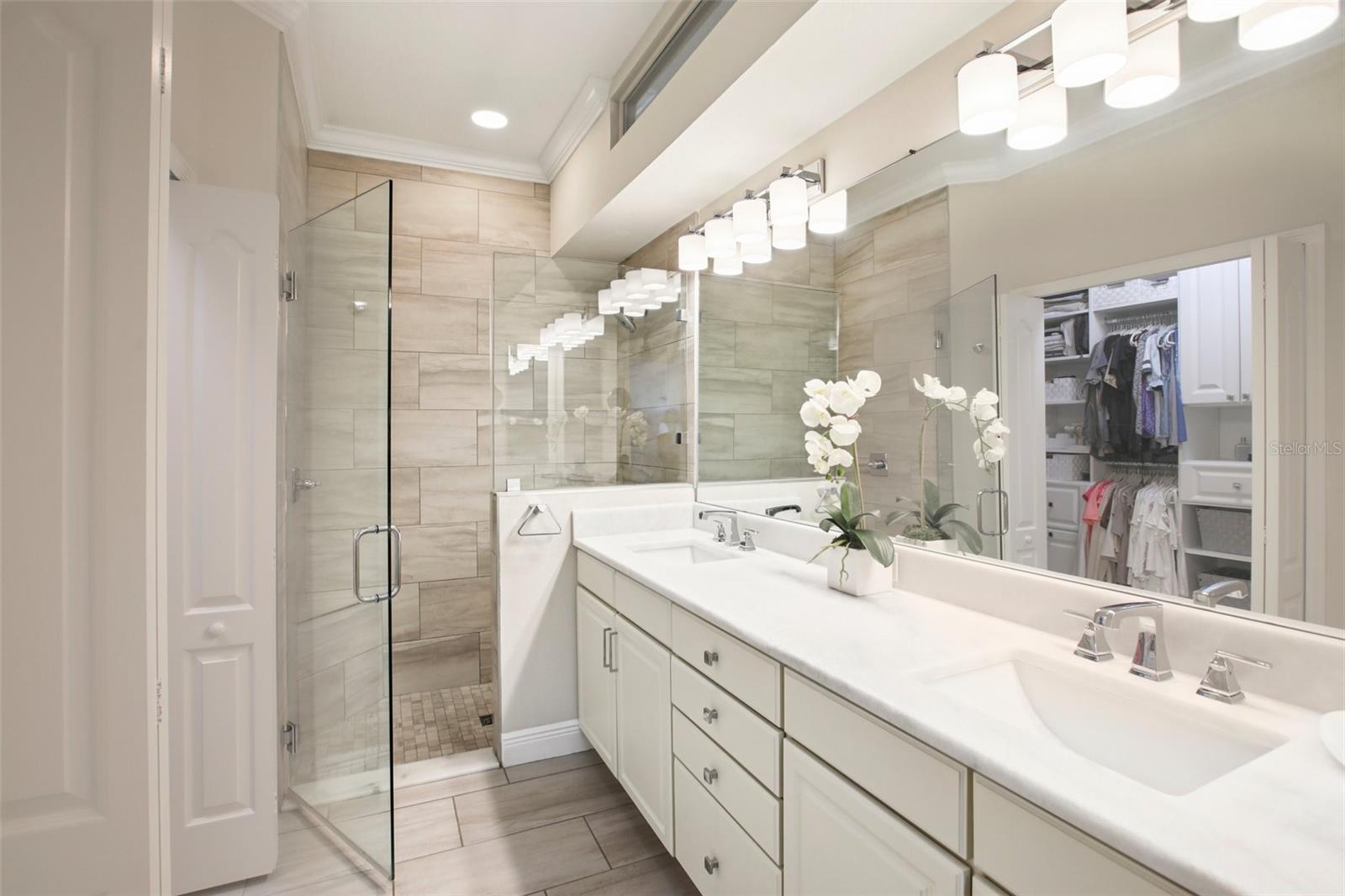 Primary ensuite bathroom looks like a spa with its marble counters