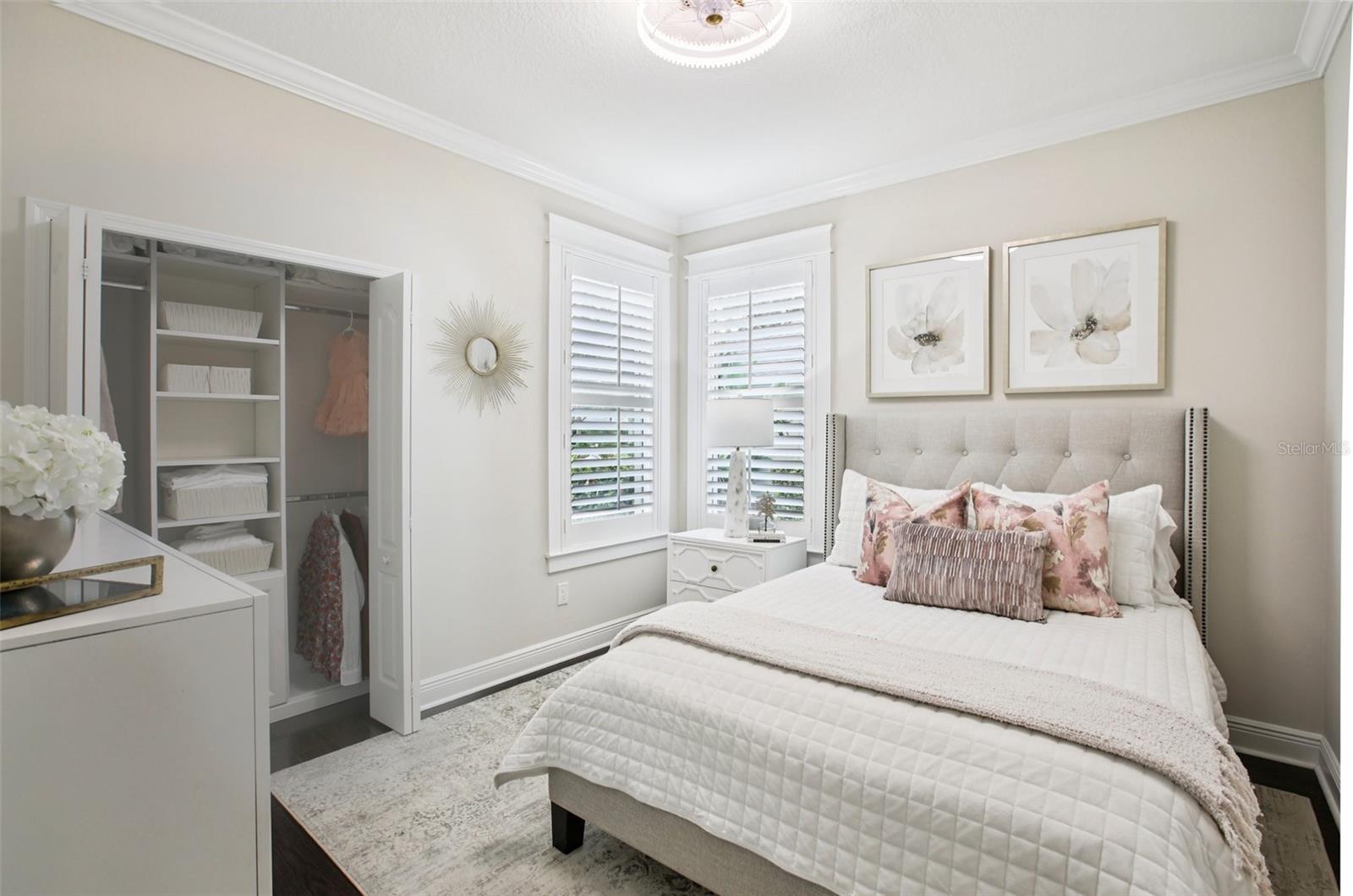 Bedroom 2 - notice the plantation shutters, engineered hardwood floors and custom built-n closet