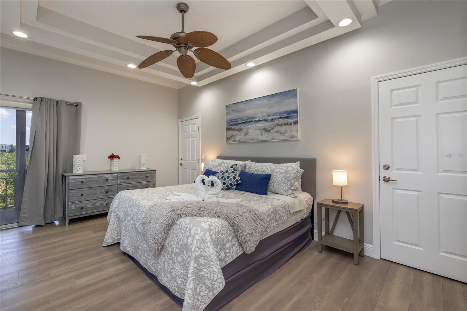 Main floor Primary room with double walk in closets and balcony access