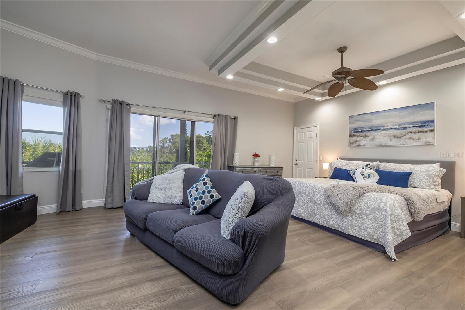Main floor primary bedroom with balcony access