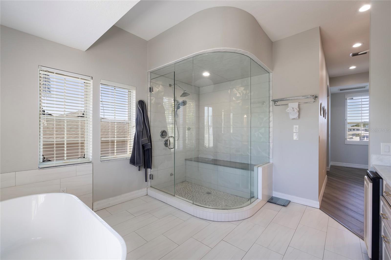 West wing primary bathroom with steam shower and soaking tub