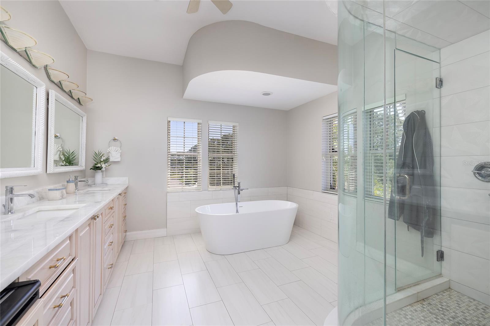 West wing primary bathroom with steam shower and soaking tub