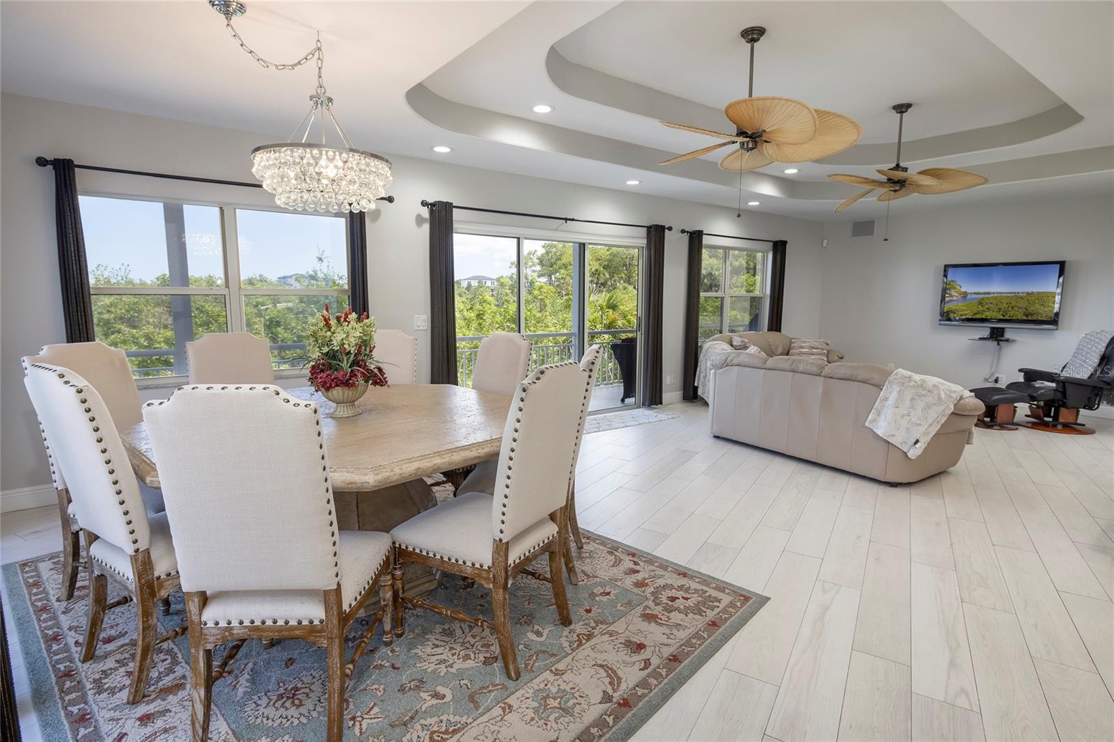 Living room and dining all with beautiful water views and access to balcony