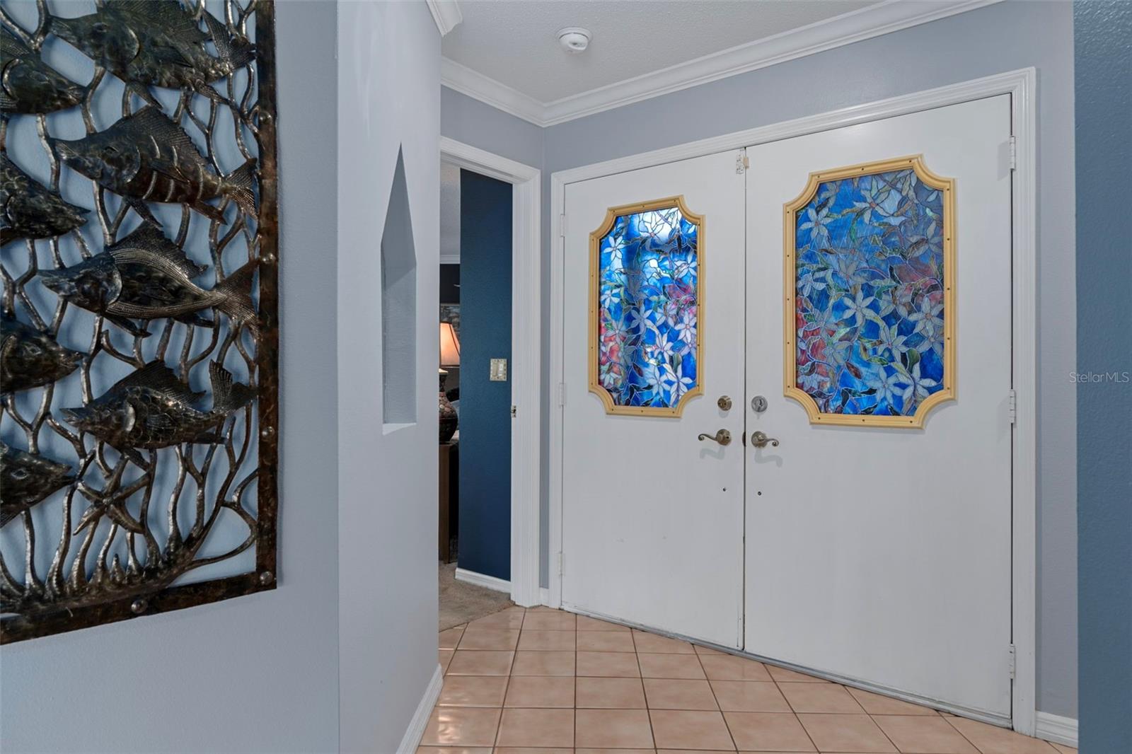 The double front doors are beautiful. What a lovely foyer