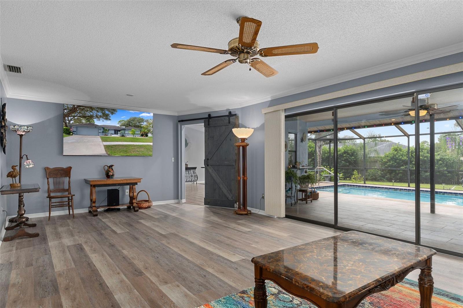 There are Sliding Glass Doors from the living room that lead out to the beautiful pool