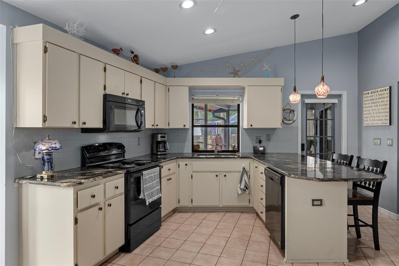 This kitchen has an abundance of cabinets and lots of counter top space