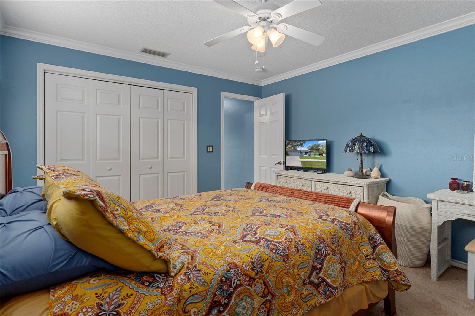 There is a fan/light and a large closet in this bedroom