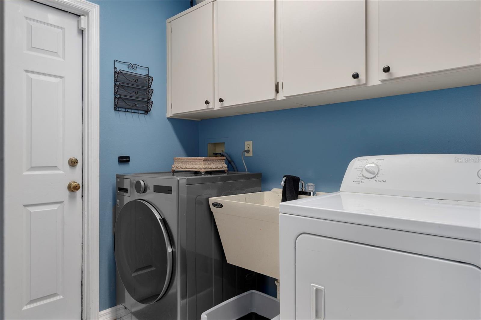There are Cabinets and a sink in the Inside Utility Room