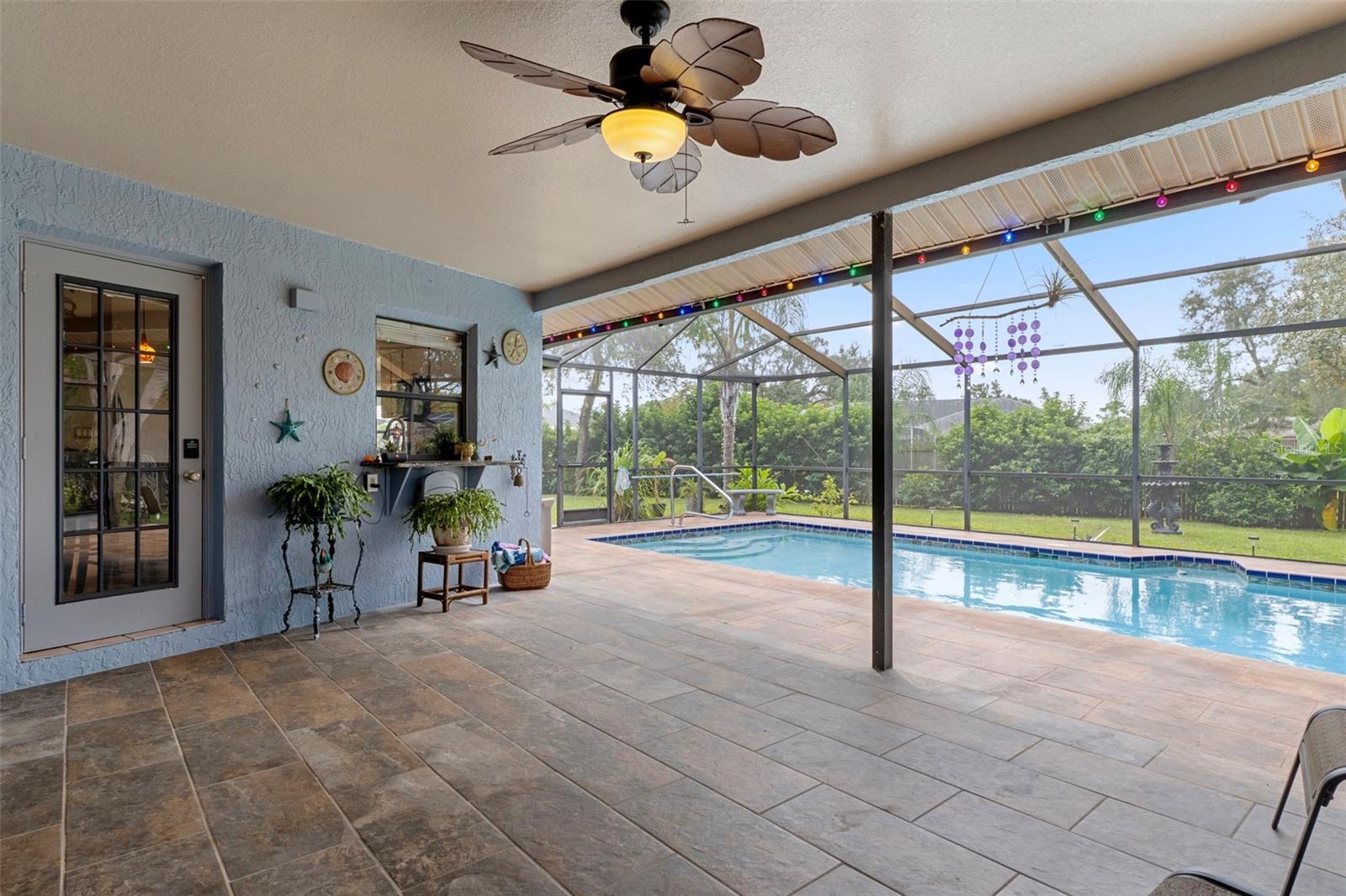 There is a french door from the kitchen to the pool area