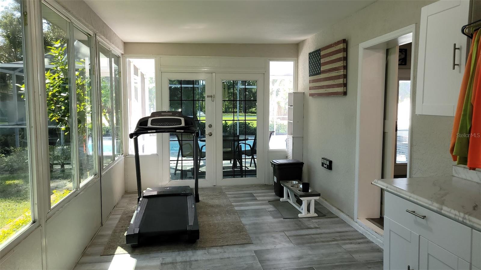 The gym area faces the pool and has doorway straight to it.