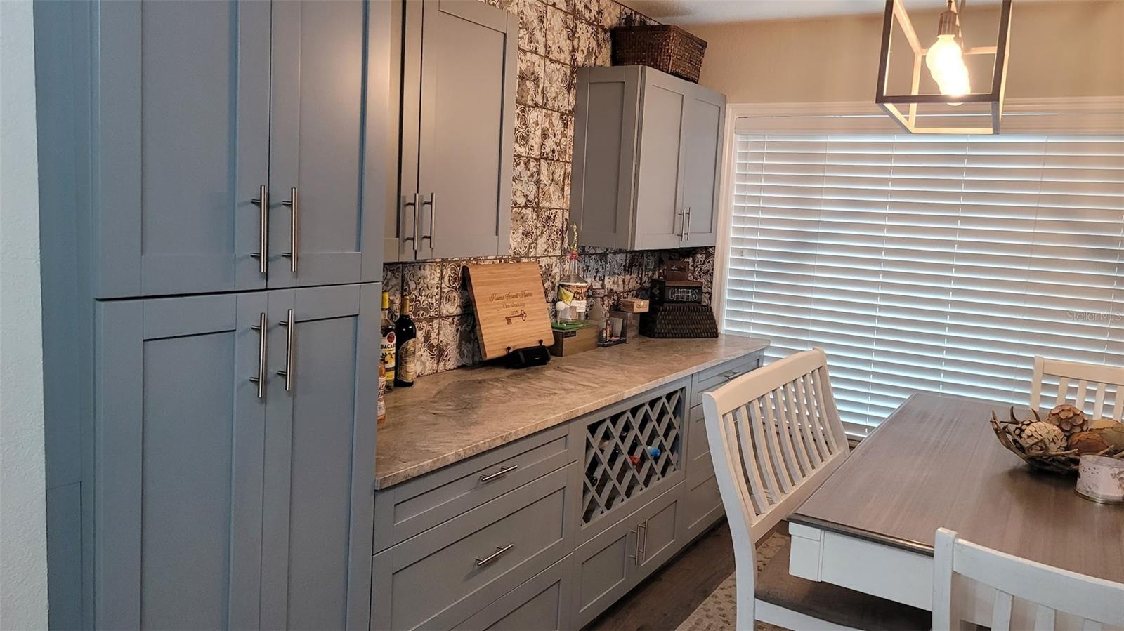 The wine bar and extra cabinets are ideal for entertaining, storage and organization.
