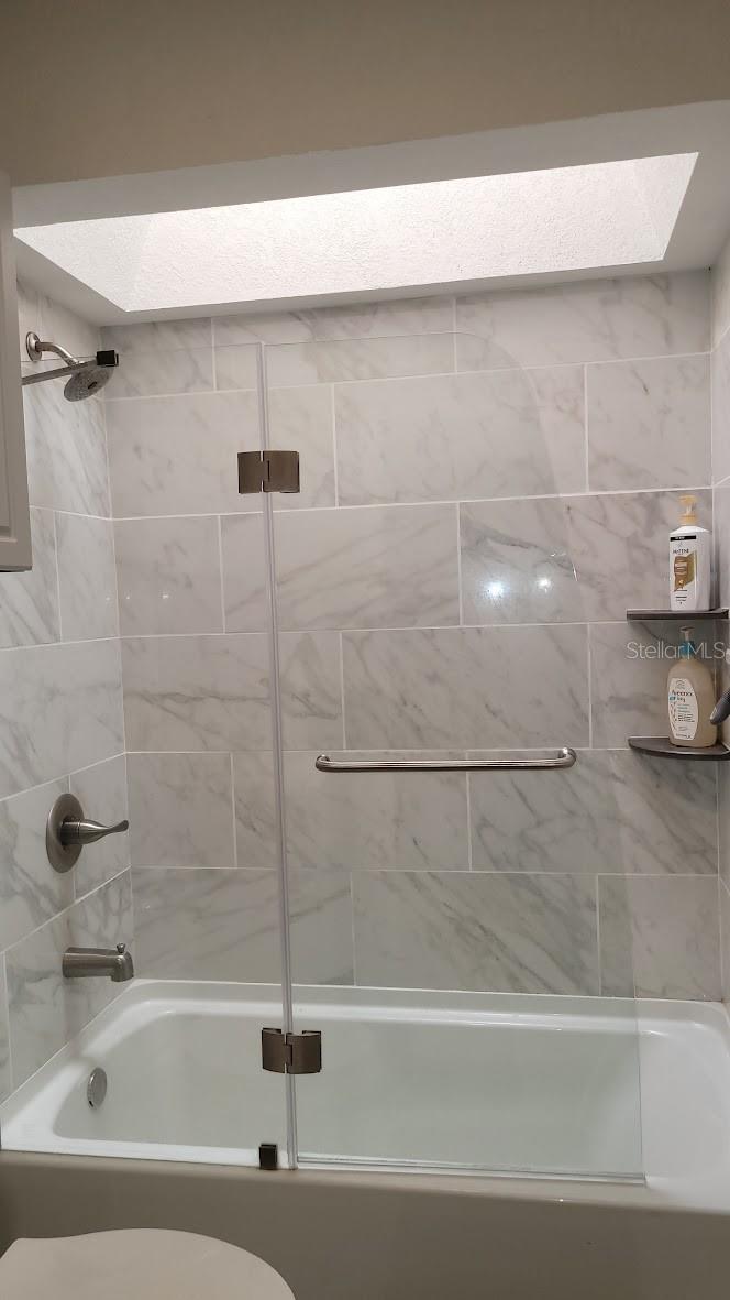 The upstairs bathroom has a tub and skylight.