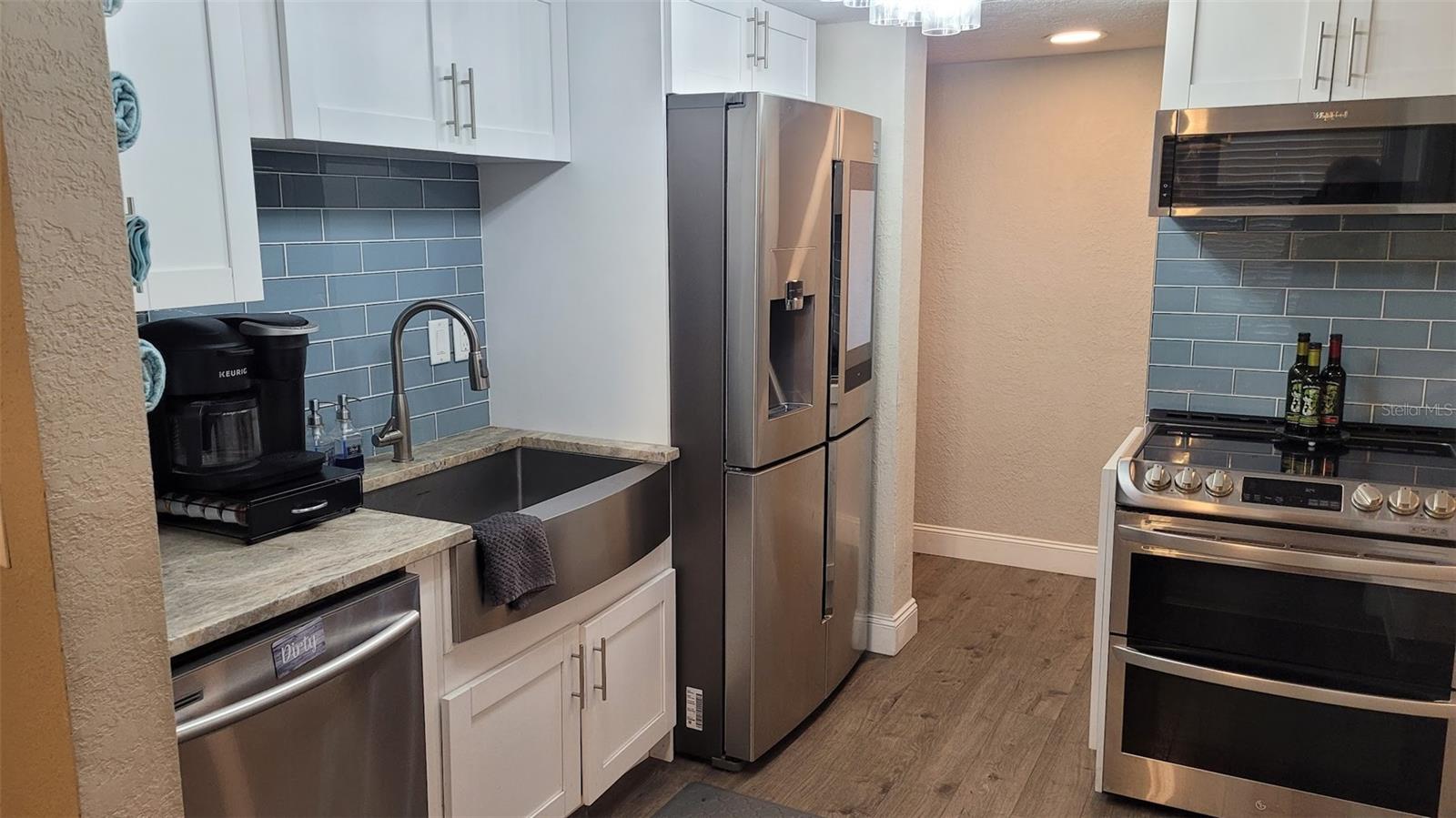 Close up of the appliances. Be sure to notice the "smart" refrigerator, double oven, (convection), and deep sink.