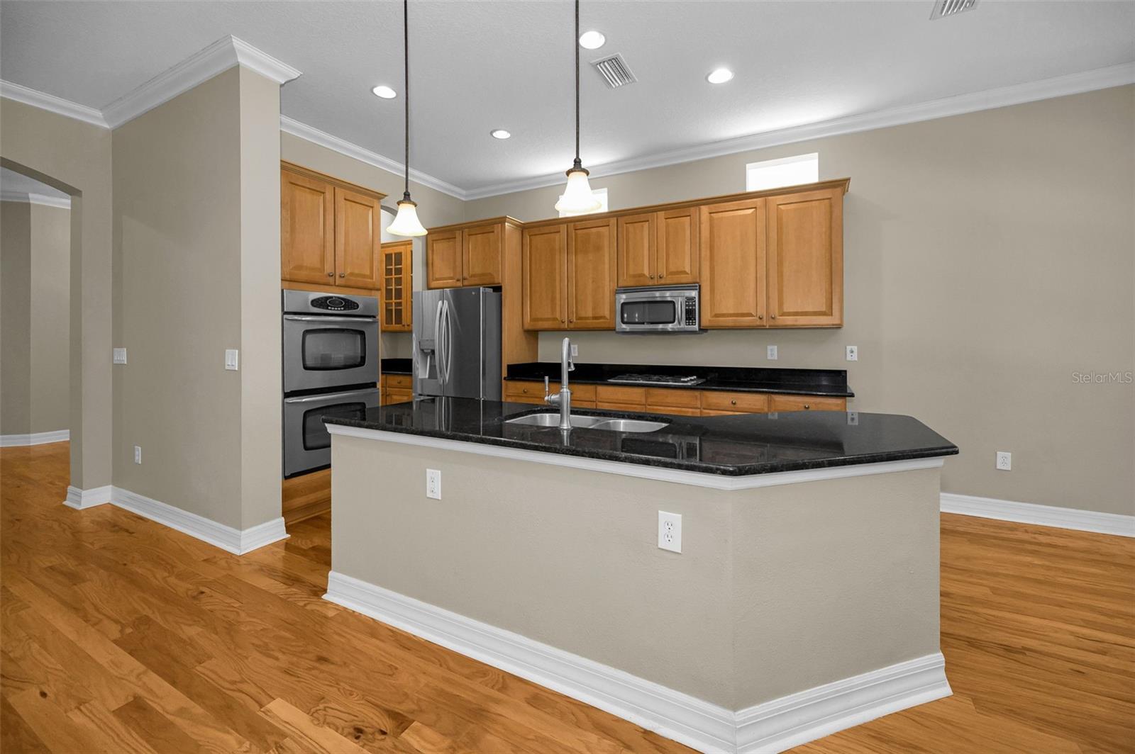 Kitchen with granite countertops and pendant lights