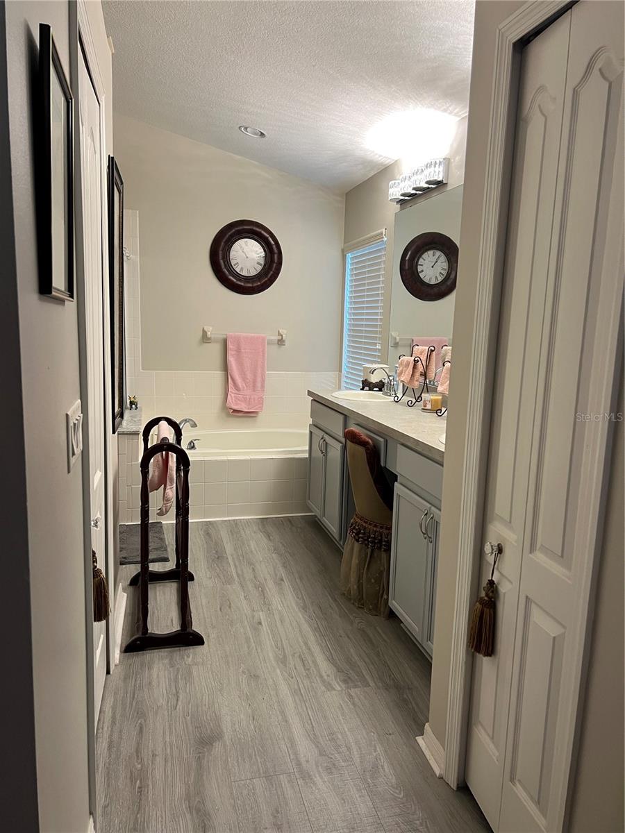 Bathroom with shower and separate tub, water closet with door.