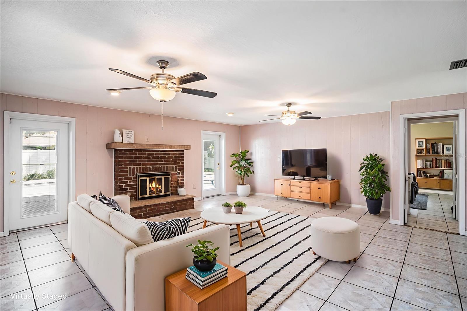 Family room featuring a wood burning fireplace overlooking the pool