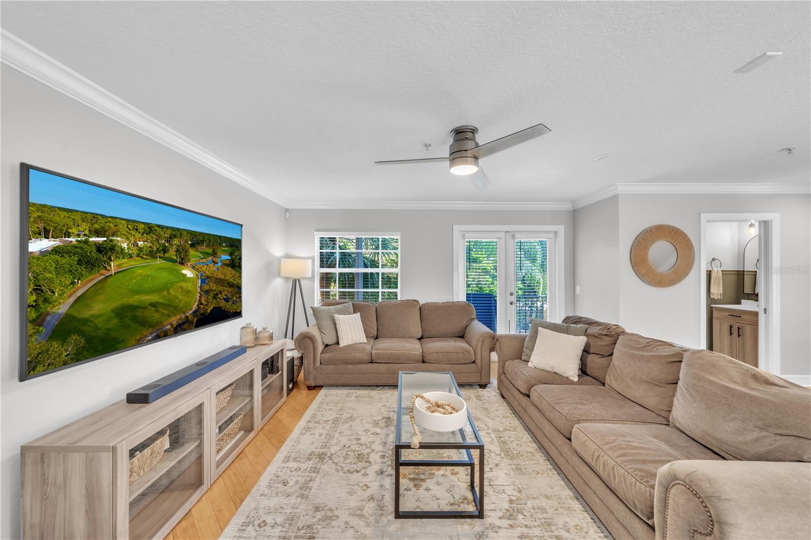 HUGE Living room with windows and french doors to balcony overlooking pool