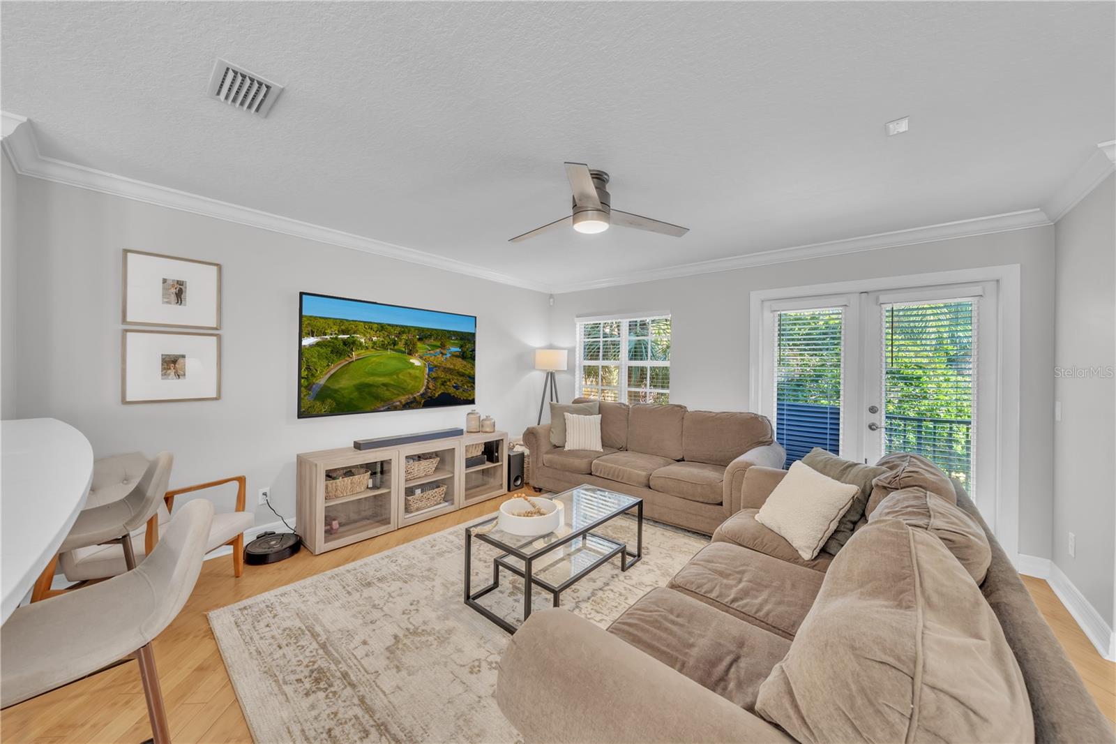 HUGE Living room with windows and french doors to balcony overlooking pool