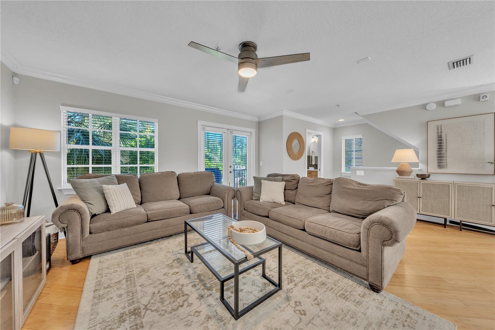 HUGE Living room with windows and french doors to balcony overlooking pool