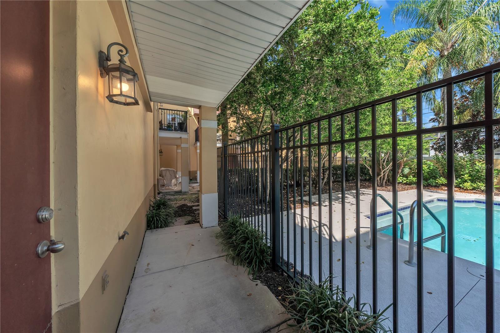 Garage rear door to additional concrete porch and pool access