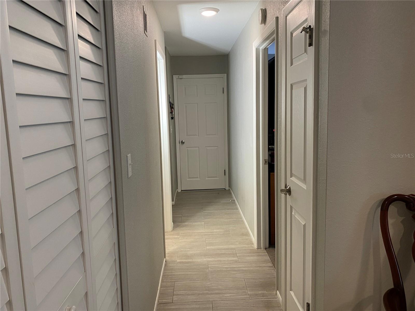 Door ahead leads to garage, right is guest room, left is guest bath