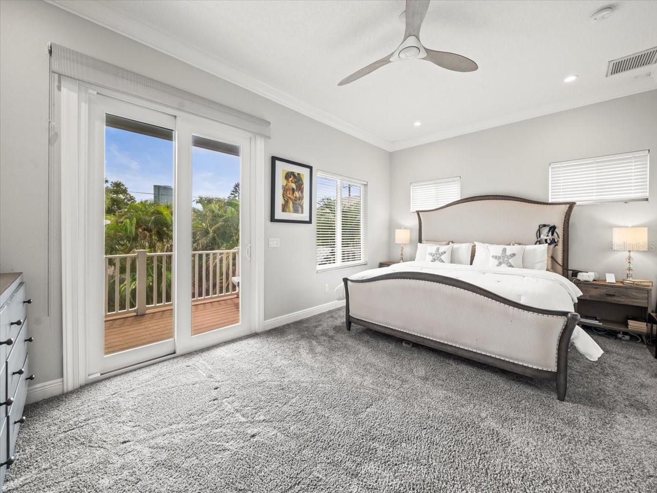 Primary suite with balcony overlooking back