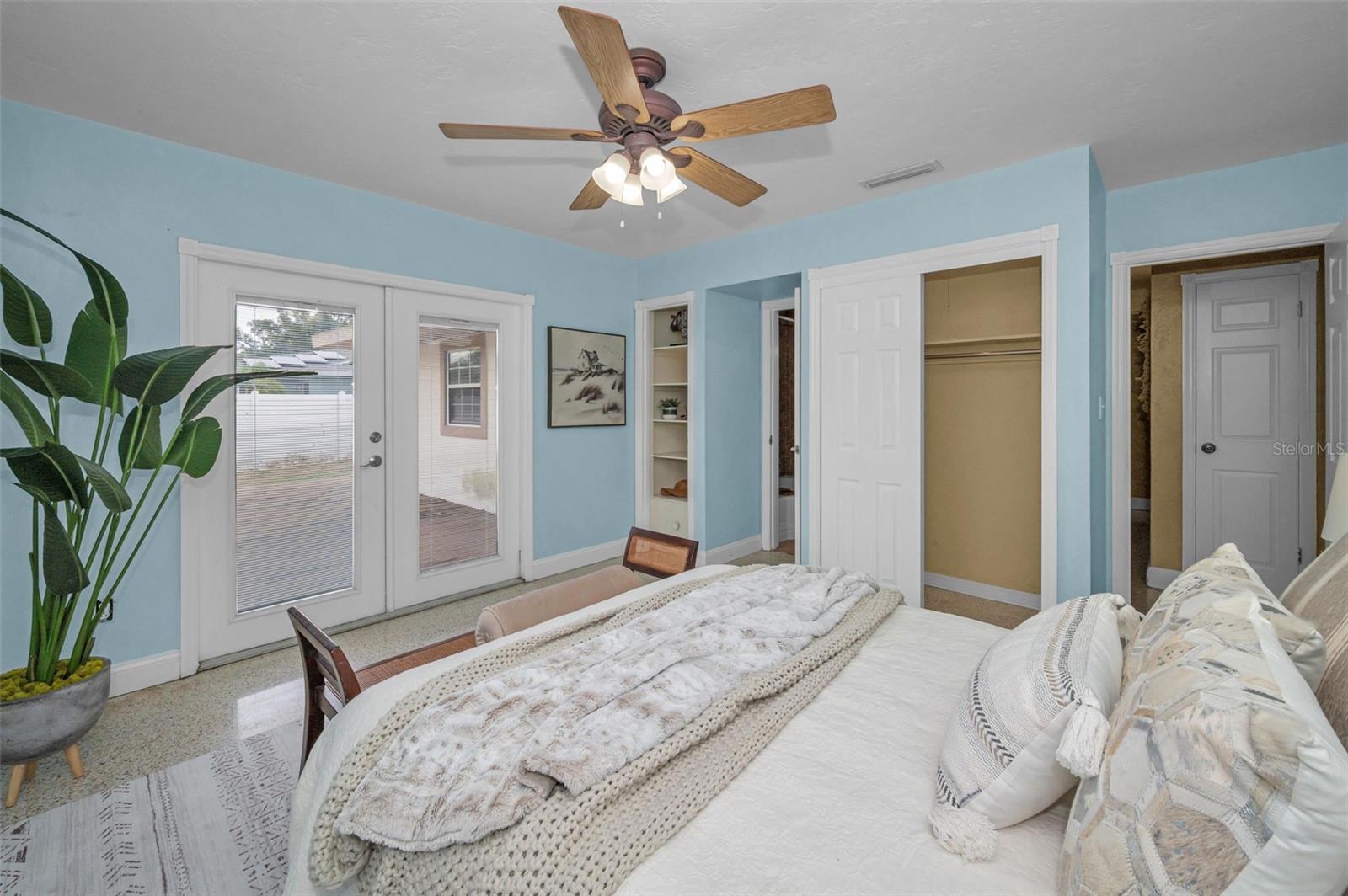 Primary bedroom as French door access to the back deck and yard.