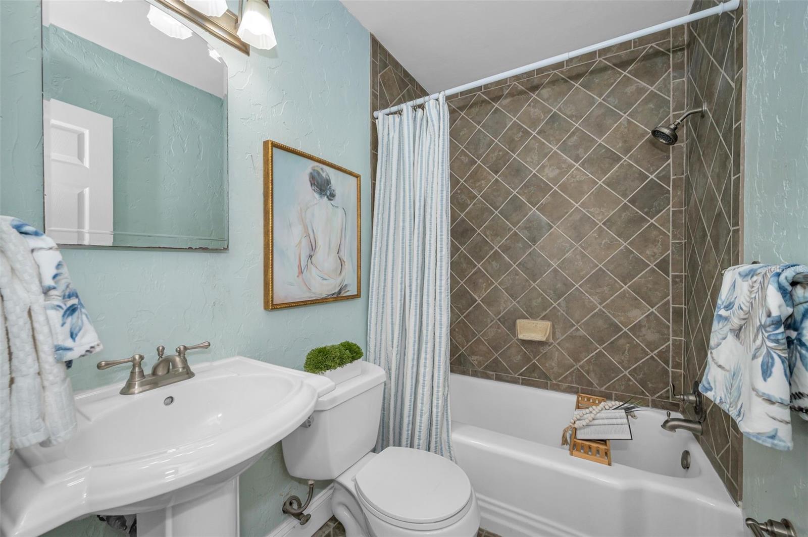 Guest bathroom with tub/shower combo.