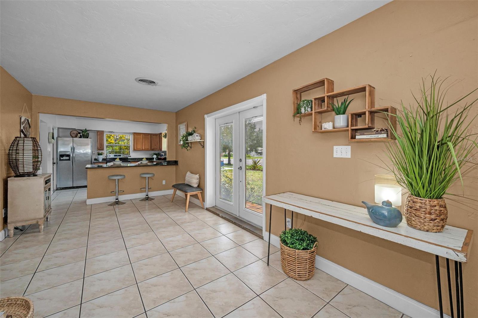 The kitchen is tucked back but easily accessed with eat-in counter.