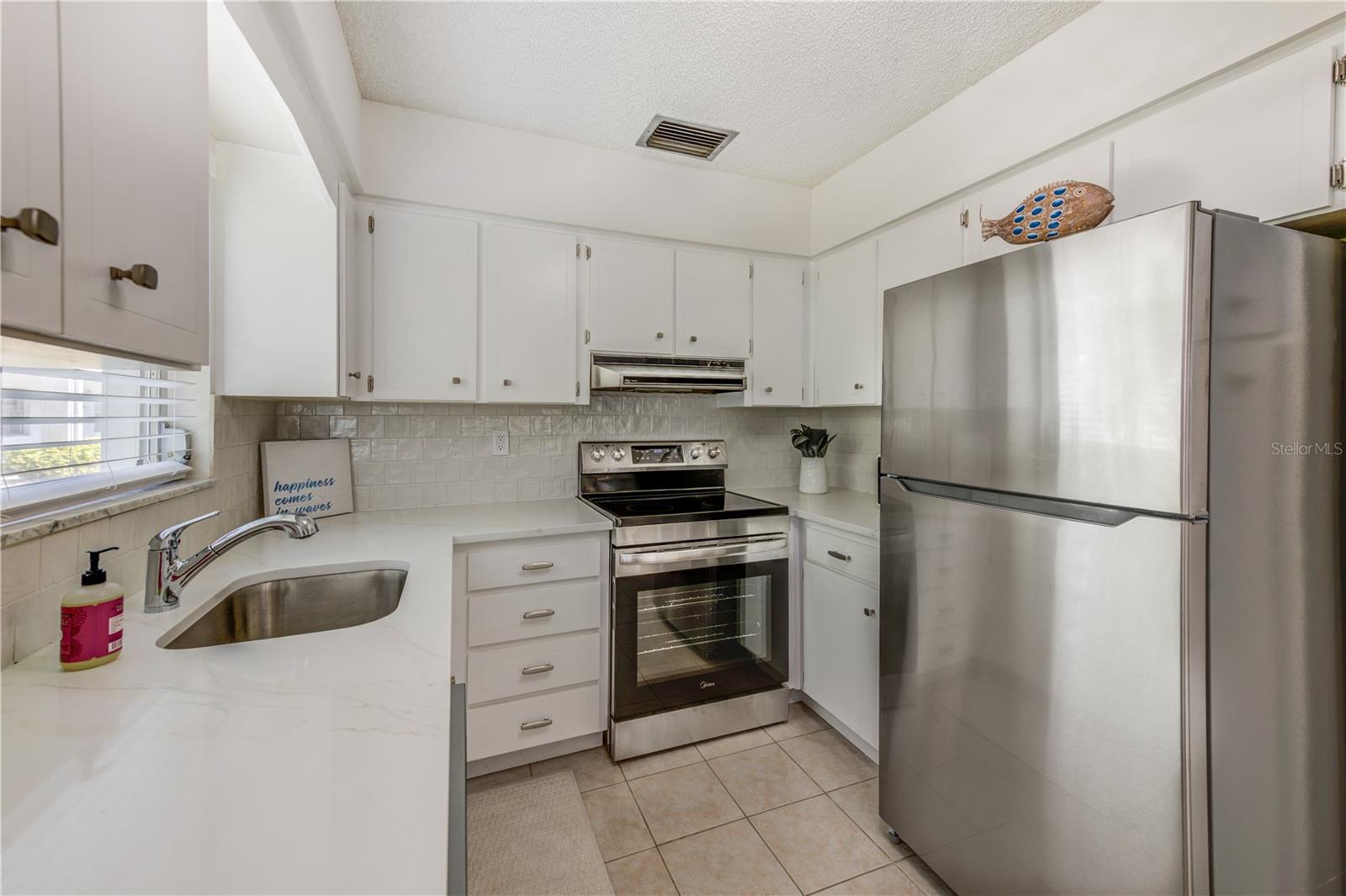 NEW QUARTZ COUNTERS AND TILE BACKSPLASH