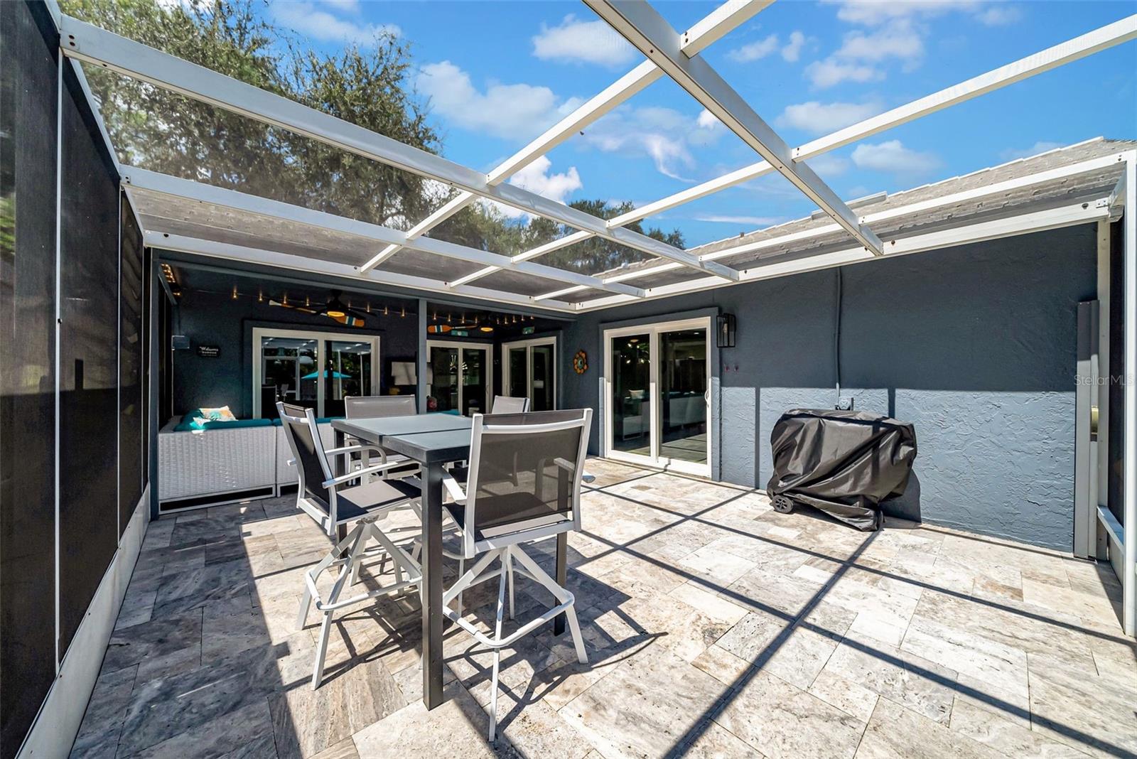 Screened-in Lanai with grilling area and covered sitting area