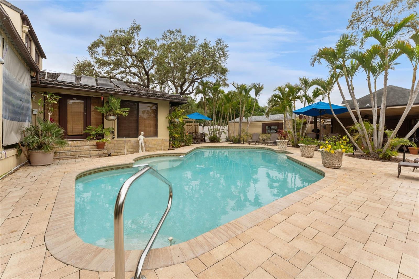 Pavered deck with Pebbletec pool