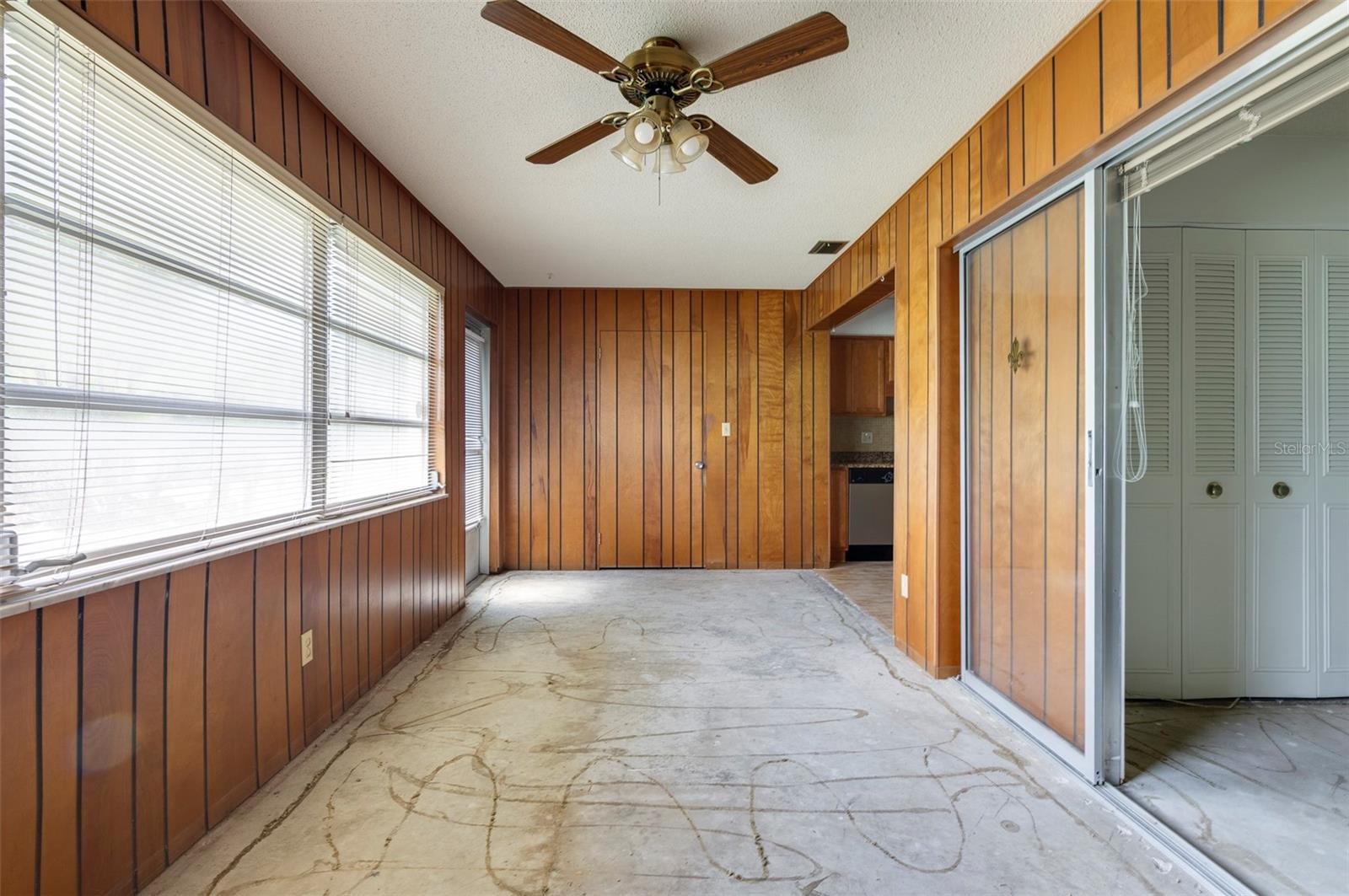 Solid Wood paneling in the Family room/Bonus Room with windows and doors to the backyard