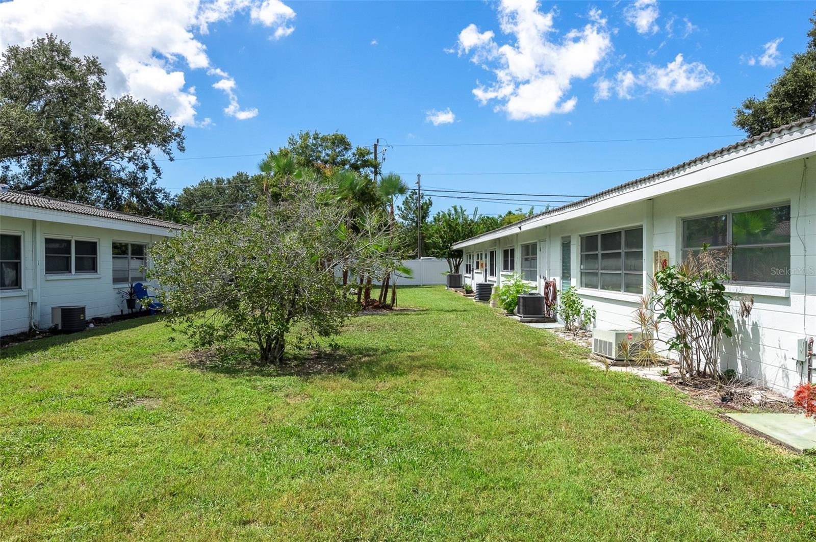 A beautiful green space in the backyard area provides privacy.